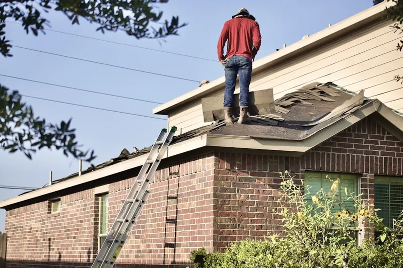 Professional roofer working on a residential roof in Corona Ranch